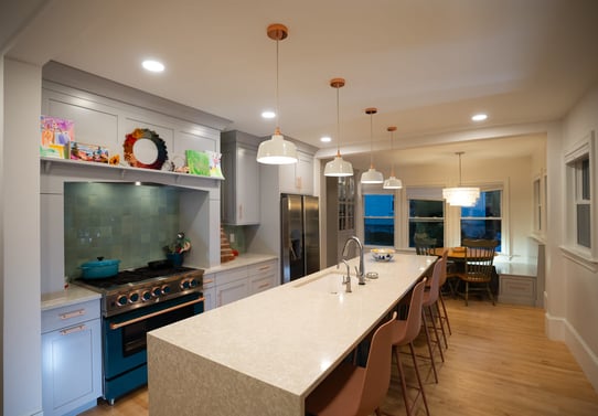 Four pendant light fixtures above island with seating in Portsmouth, NH whole home remodel