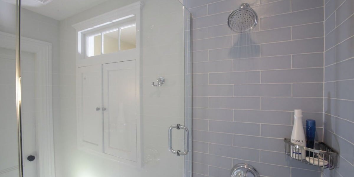 bathroom shower head with subway tiling