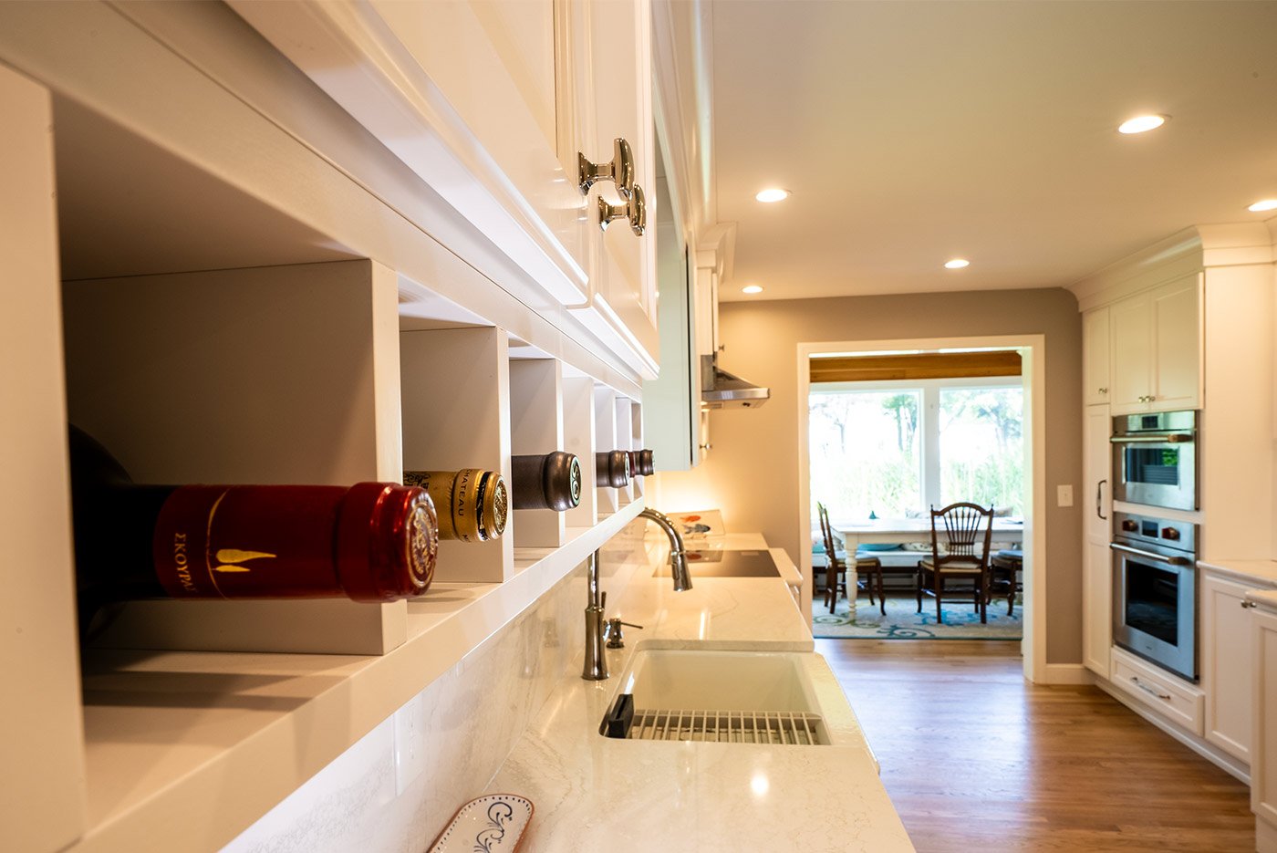 Built-in wine storage and white cabinetry in a bright Seacoast, NH kitchen renovation by Oxland Builders Built-in wine storage and white cabinetry in a bright Seacoast, NH kitchen renovation by Oxland Builders