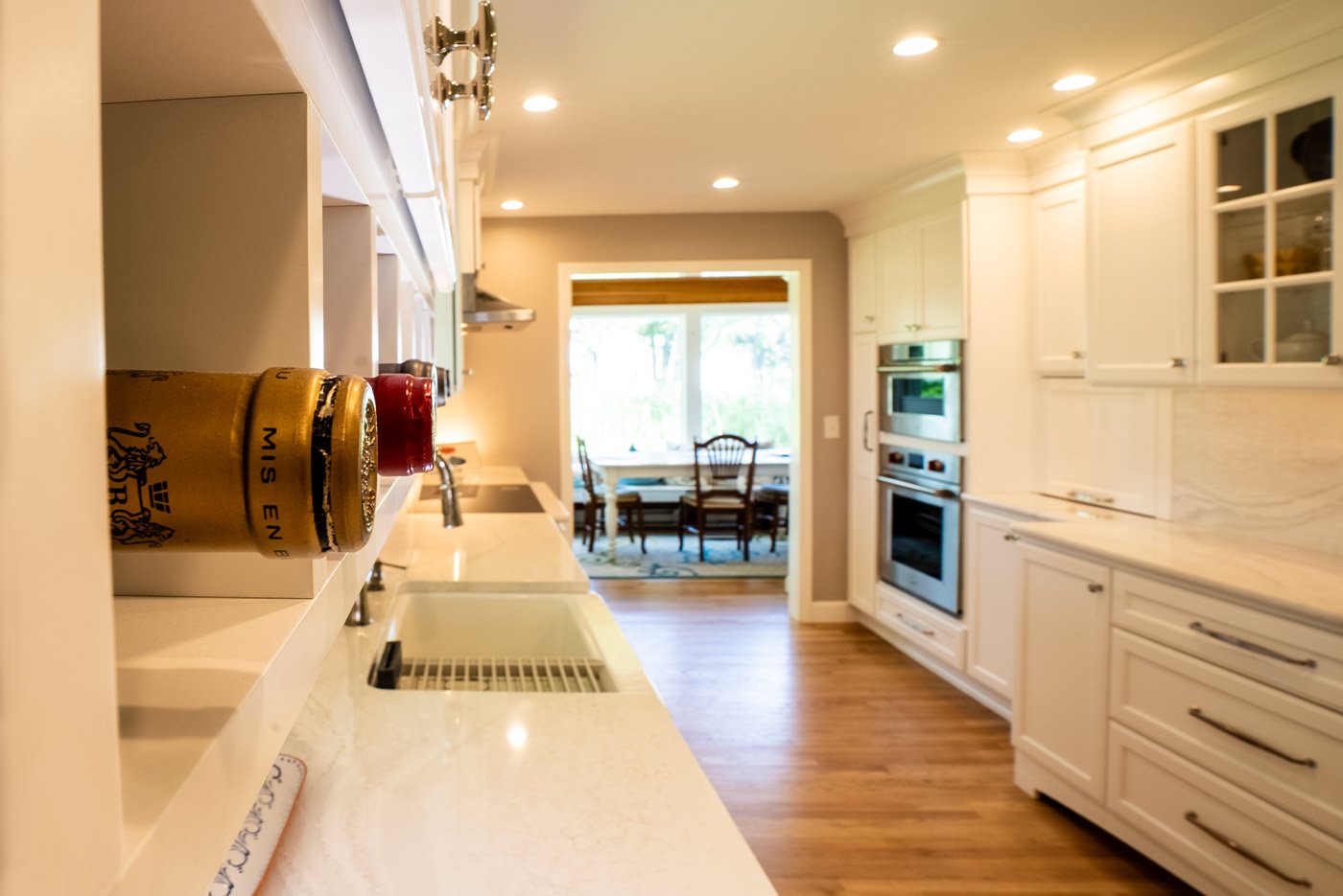 lose-up of wine bottle cubbies above marble counters in a Seacoast, NH kitchen built by Oxland Builders
