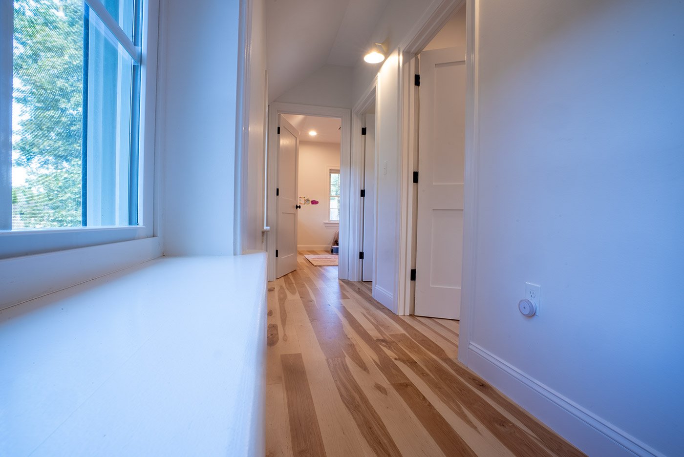 Long hallway with built-in window ledge, built by Oxland Builders