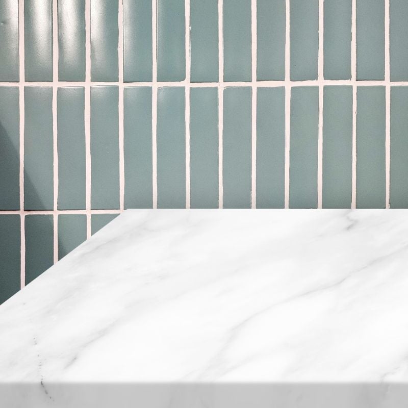 Teal vertical tile backsplash with white marble countertop detail by Oxland Builders