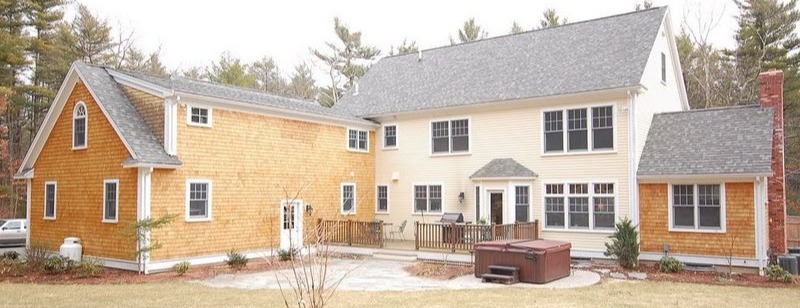 Backyard exterior of custom home with deck area