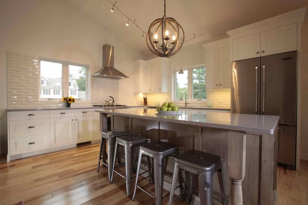 Custom kitchen remodel with vaulted ceilings and island with seating beneath pendant light