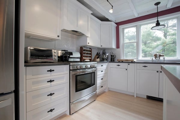 white kitchen cabinets with herringbone backsplash in New Hampshire kitchen remodel