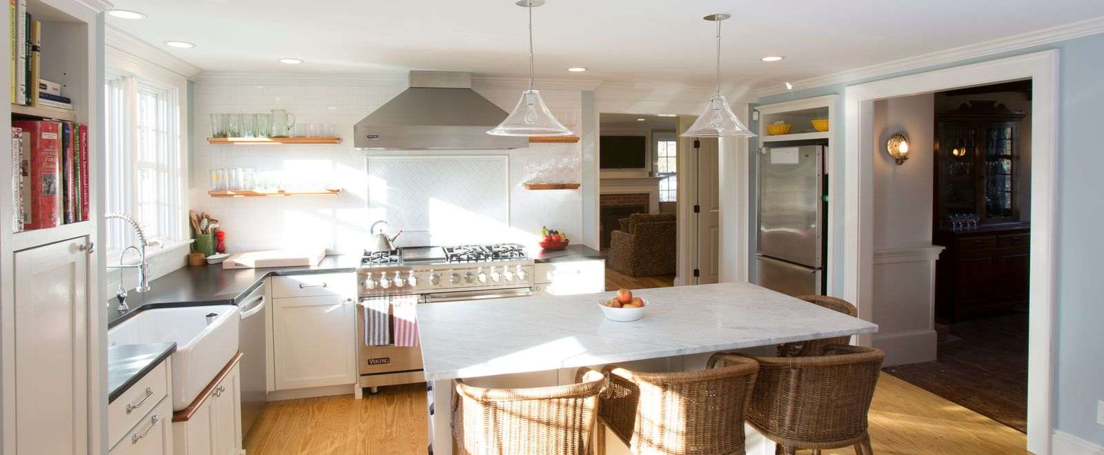White kitchen renovWhite kitchen remodel with white tile backsplash and kitchen island