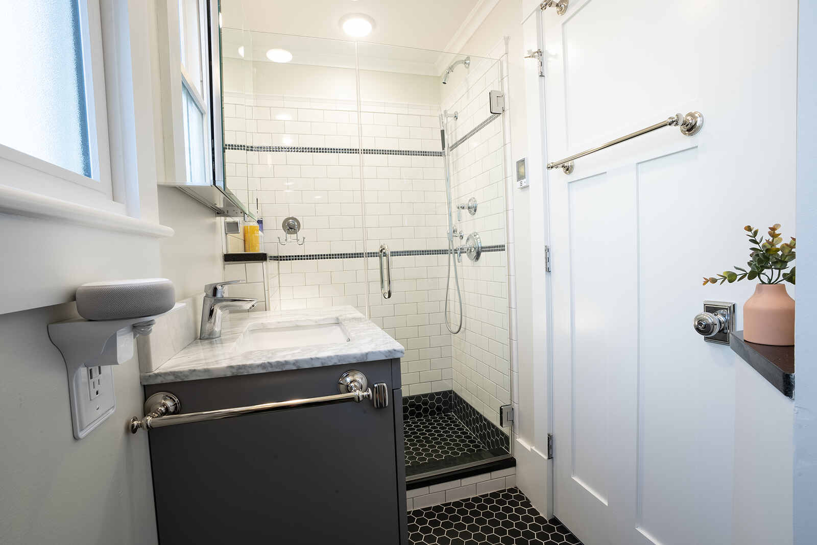 white subway tile and black hexagonal tile on flooring in bathroom remodel in new hampshire