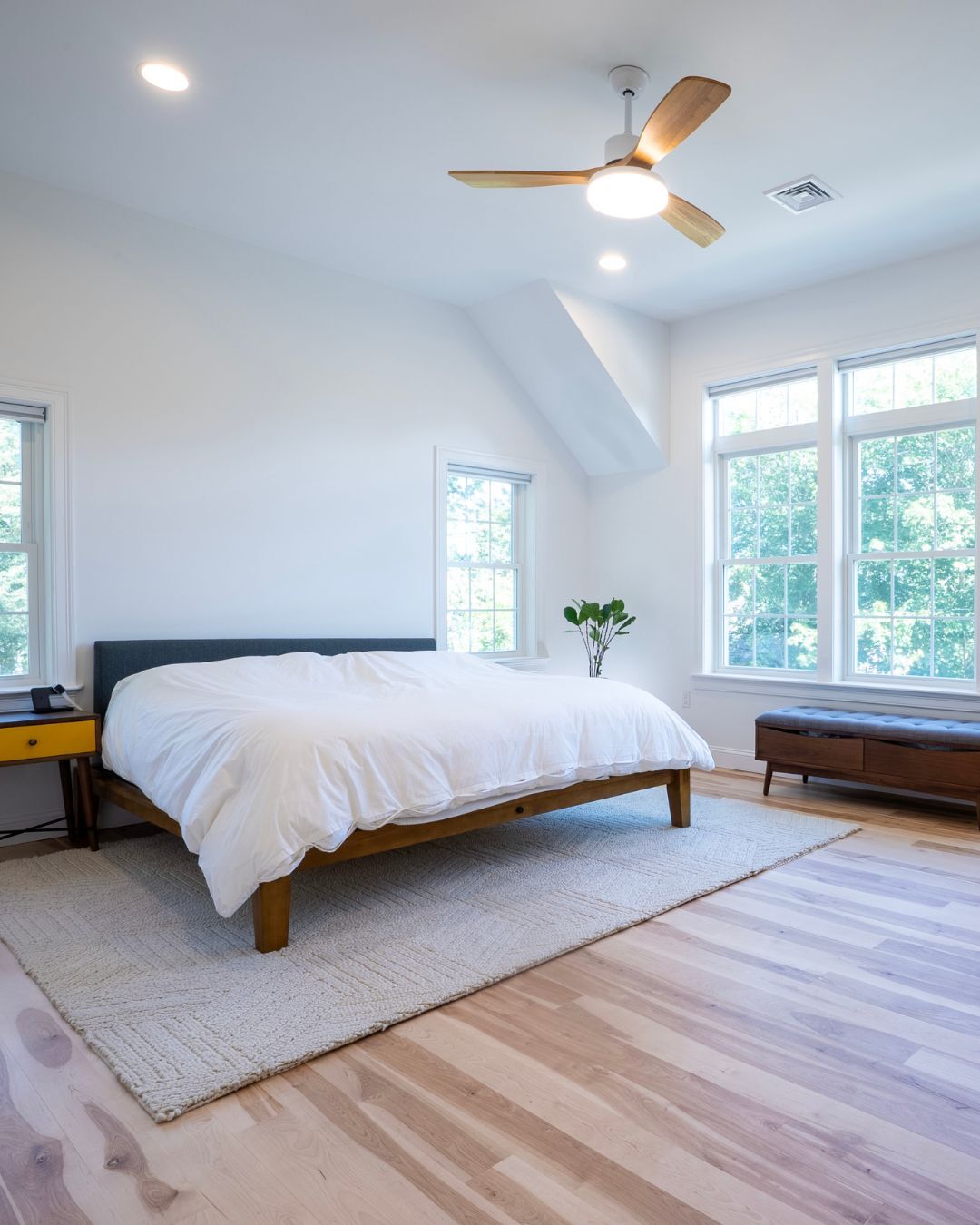 Bright and airy New Hampshire bedroom with natural light, wood floors, and modern decor-1