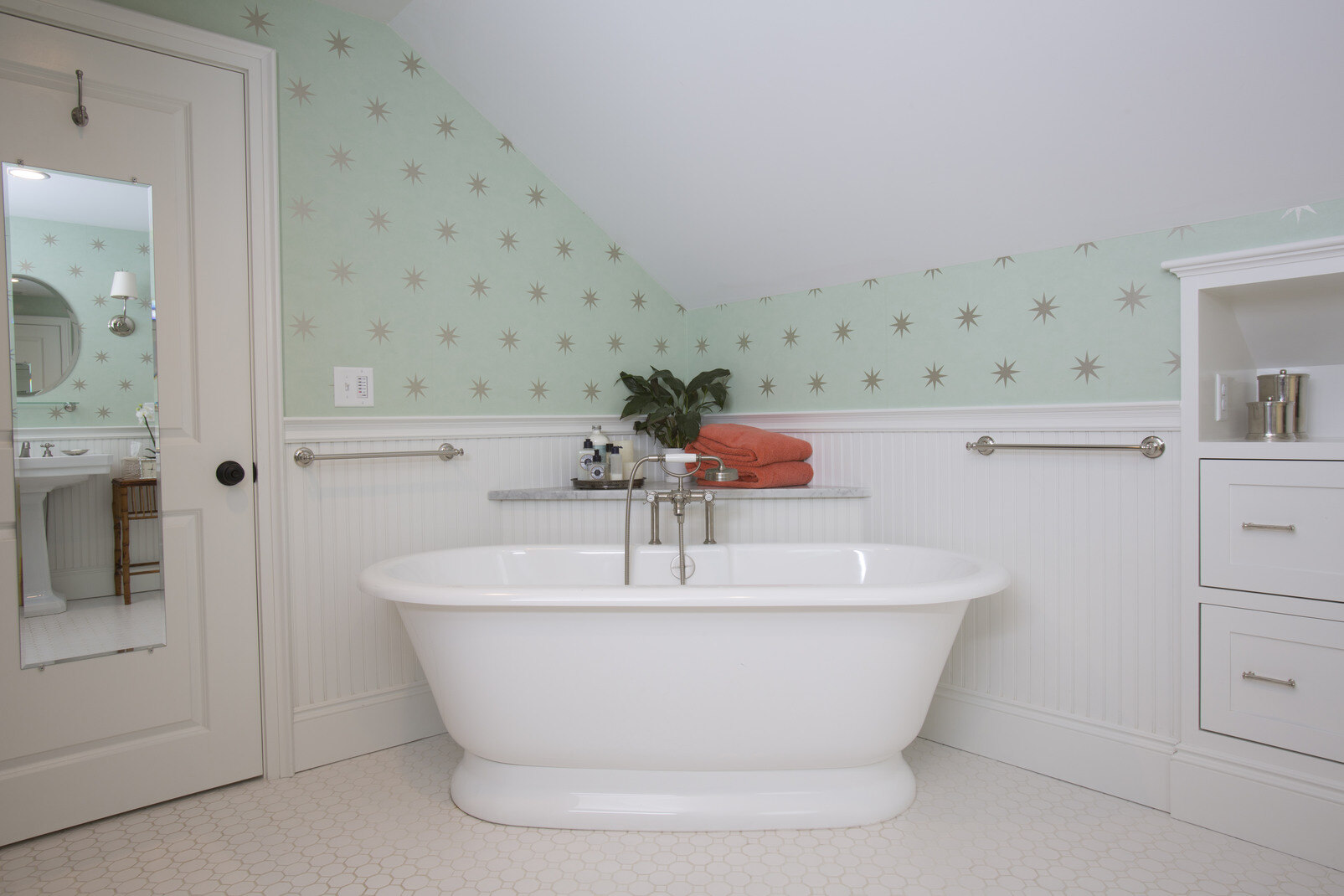 Contemporary bathroom featuring teal accents and custom cabinetry, remodeled by Oxland Builders in New Hampshire