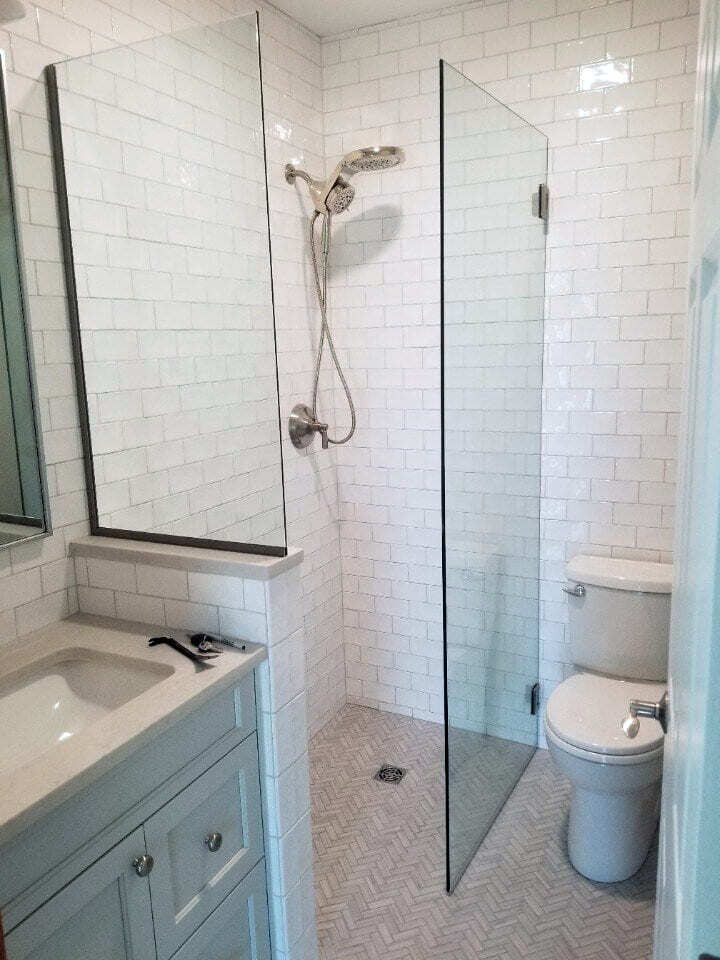 Small bathroom with a walk-in shower and subway tile design, remodeled by Oxland Builders in Portsmouth, New Hampshire