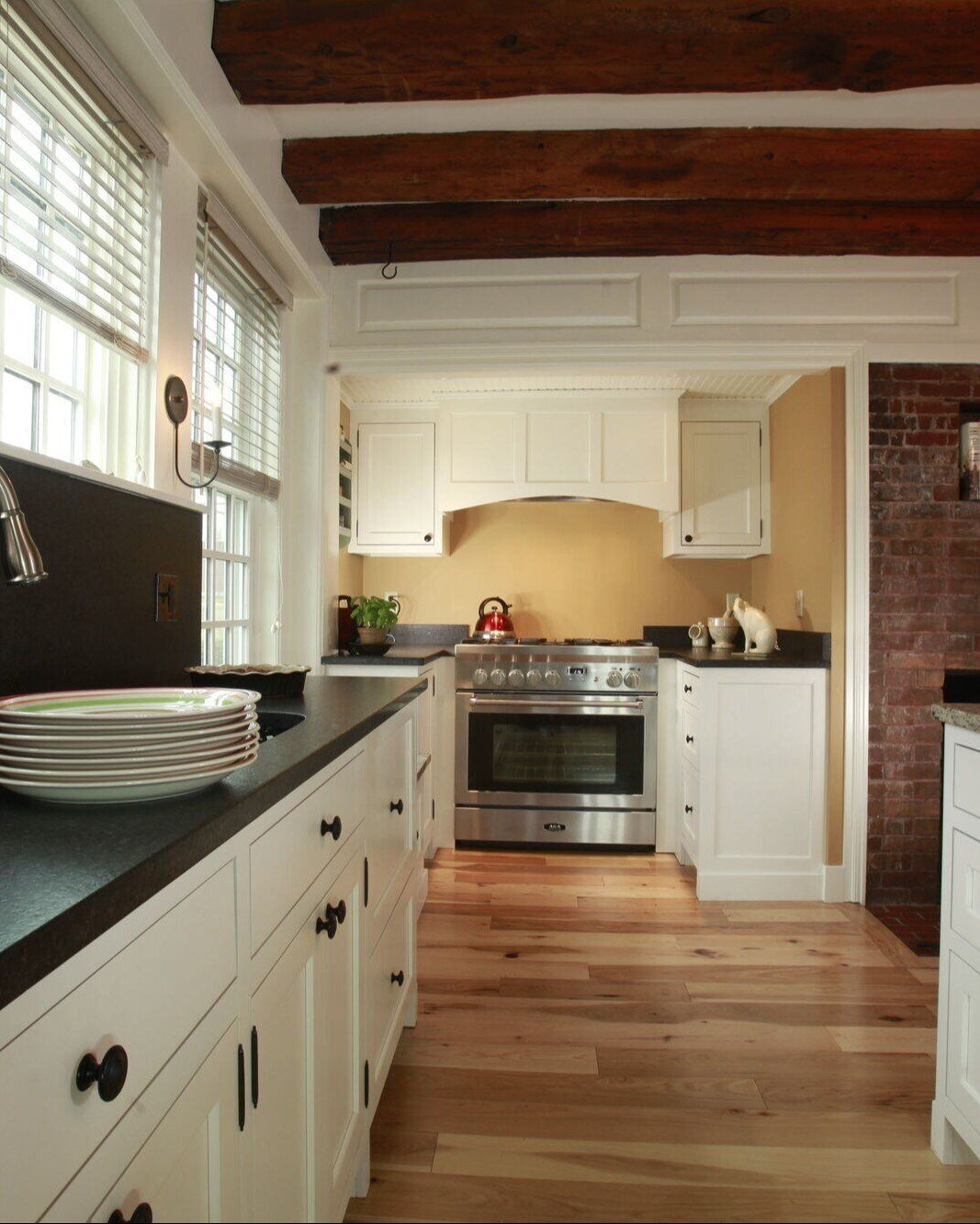 New Hampshire kitchen remodel by Oxland Builders, with a mix of rustic and modern elements in a farmhouse-inspired design