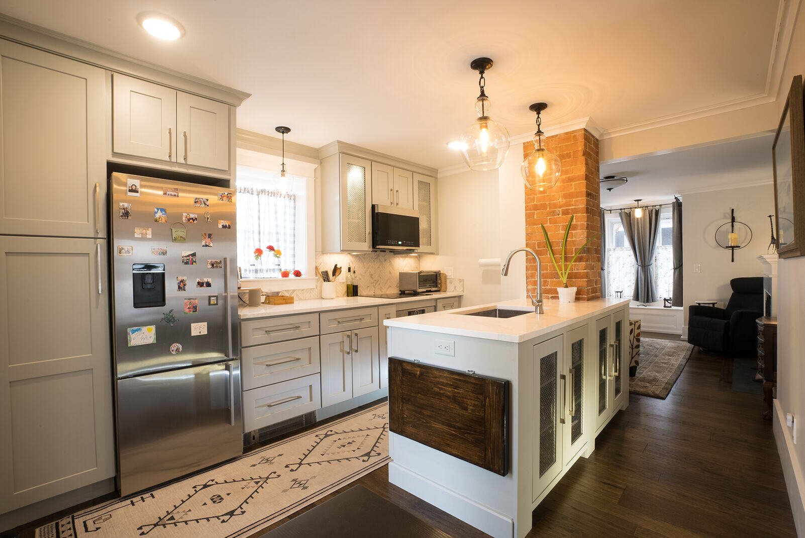 Spacious kitchen with an island, stainless steel appliances, and brick accent wall, remodeled by Oxland Builders in New Hampshire Spacious kitchen with an island, stainless steel appliances, and brick accent wall, remodeled by Oxland Builders in New Hampshire