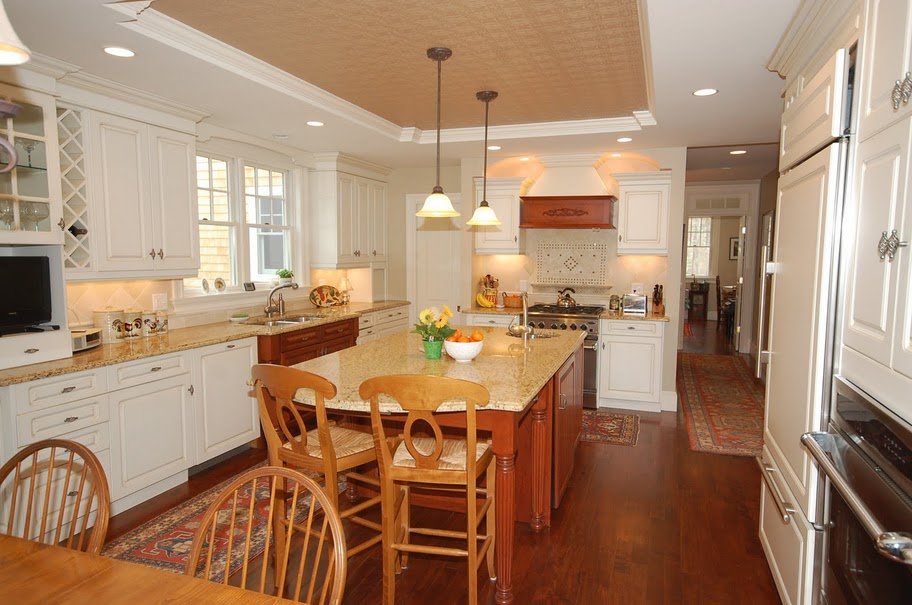 Custom white shaker cabinets and inset ceiling details in remodel