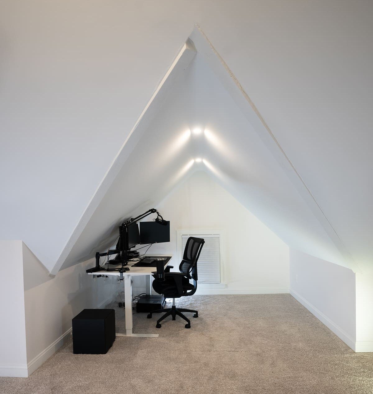 Office chair and desk in finished attic remodel with angled ceiling by Oxland Builders Office chair and desk in finished attic remodel with angled ceiling by Oxland Builders