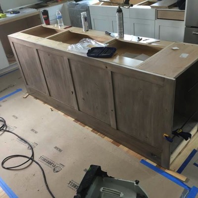 Kitchen island in progress with custom storage built-in