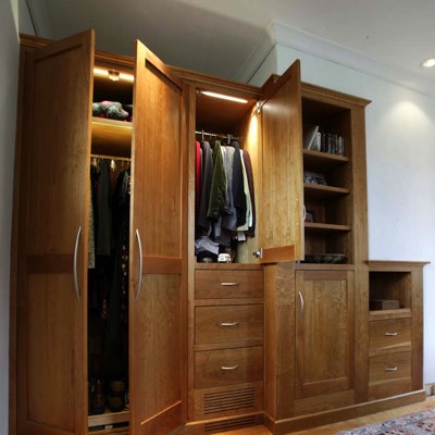 Illuminated wardrobe with custom-built cabinetry