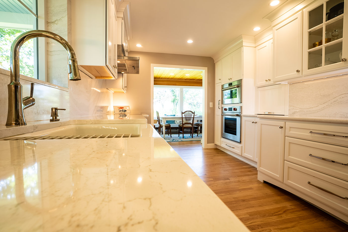 Bright kitchen with marble counters and modern fixtures by Oxland Builders in New Hampshirea Bright kitchen with marble counters and modern fixtures by Oxland Builders in New Hampshirea