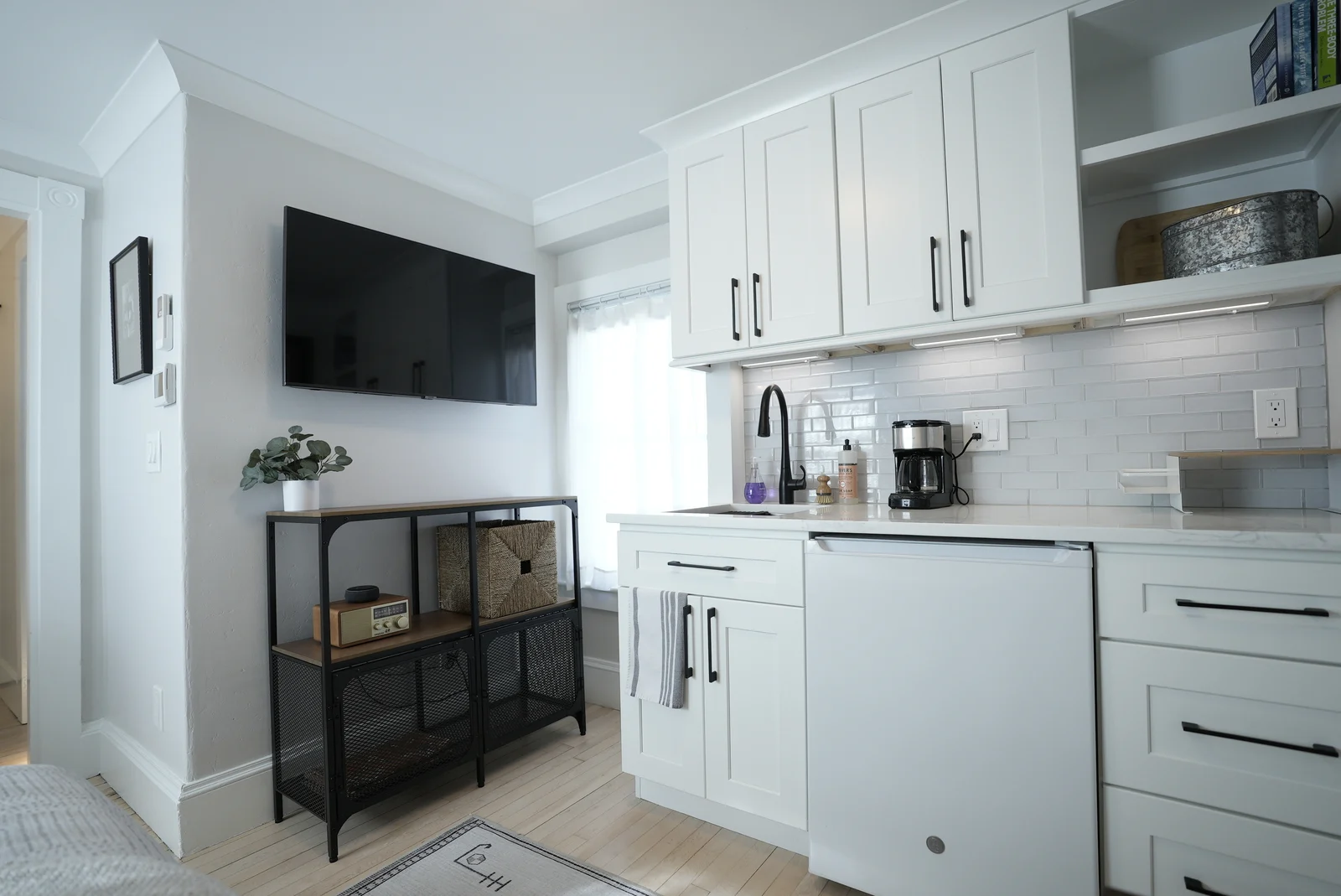 cozy bedroom with half kitchen and wall mounted tv in whole home remodel new hampshire cozy bedroom with half kitchen and wall mounted tv in whole home remodel new hampshire