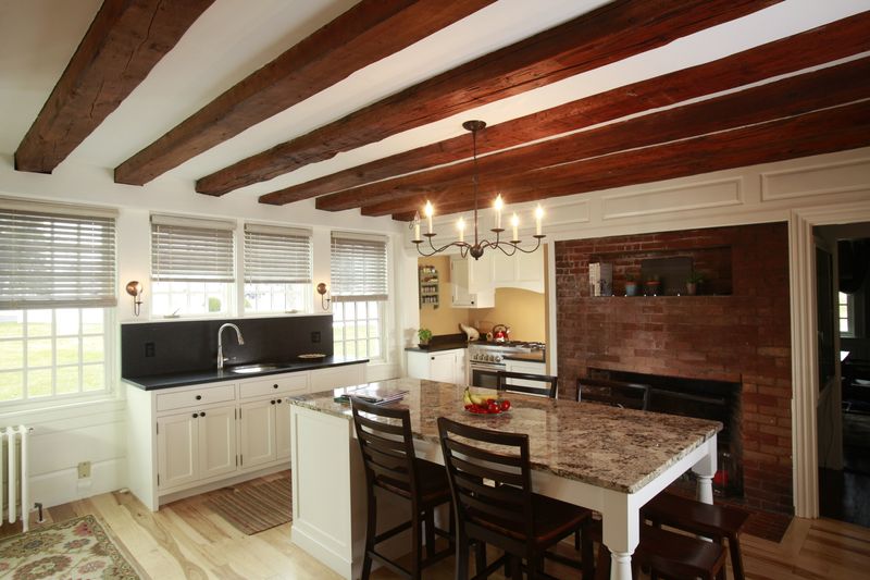 Custom kitchen remodel with pendant lighting and beamed ceiling and kitchen island
