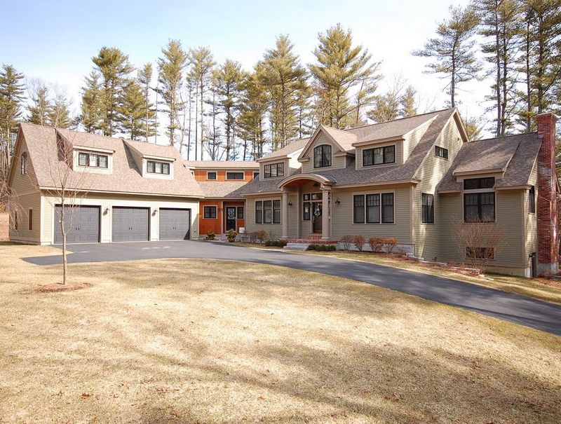 Luxury custom home exterior and front yard with 3-car garage